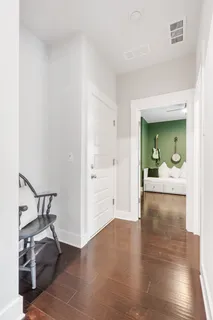 a view of a hallway view with wooden floor and a way to living room