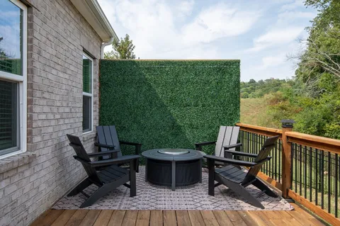 a view of a lounge chair and table in the balcony