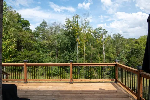 a view of balcony with wooden floor and fence