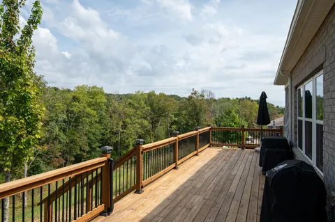 a view of a balcony with couches and wooden floor