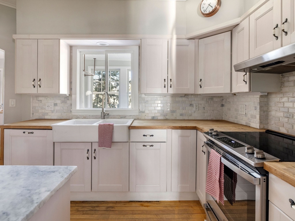 4 Latisquama Road Southborough, MA 01772 - Photo 22 of 42 a kitchen with stainless steel appliances granite countertop a sink stove and cabinets
