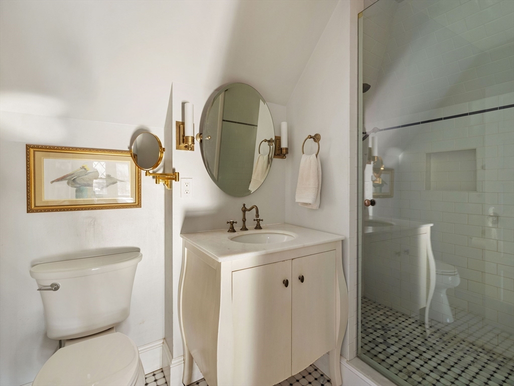 4 Latisquama Road Southborough, MA 01772 - Photo 37 of 42 a bathroom with a granite countertop toilet sink and mirror