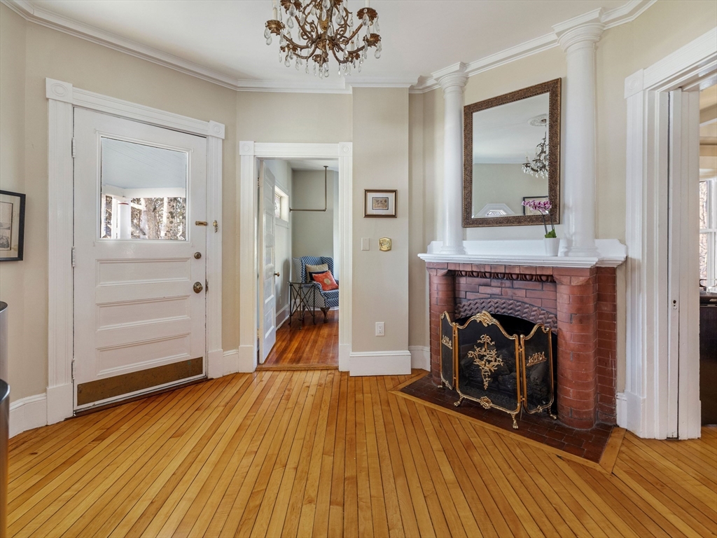4 Latisquama Road Southborough, MA 01772 - Photo 10 of 42 a view of a livingroom with a fireplace and wooden floor