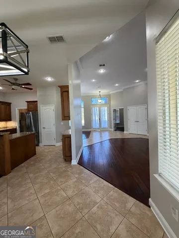 a view of a livingroom with a hardwood floor and a ceiling fan