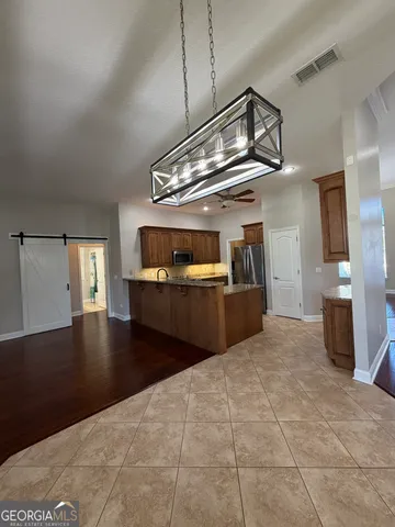 an empty room with wooden floor fireplace and windows