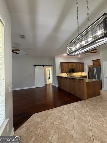 an empty room with wooden floor fireplace and cabinet