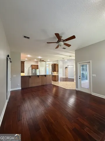 a kitchen with a stove sink and cabinets