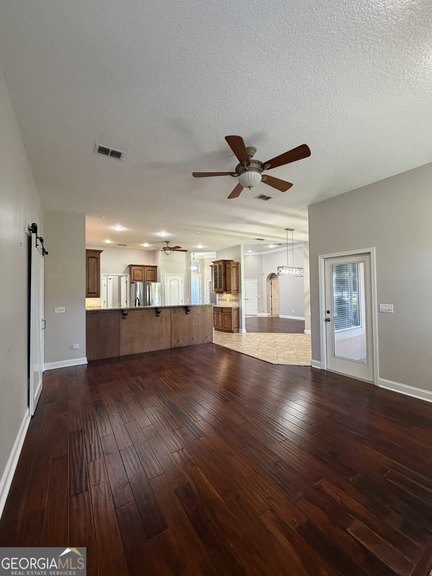 108 Heron's Nest Circle Kingsland, GA 31548 - Photo 14 of 62 a view of a livingroom with a hardwood floor and a ceiling fan