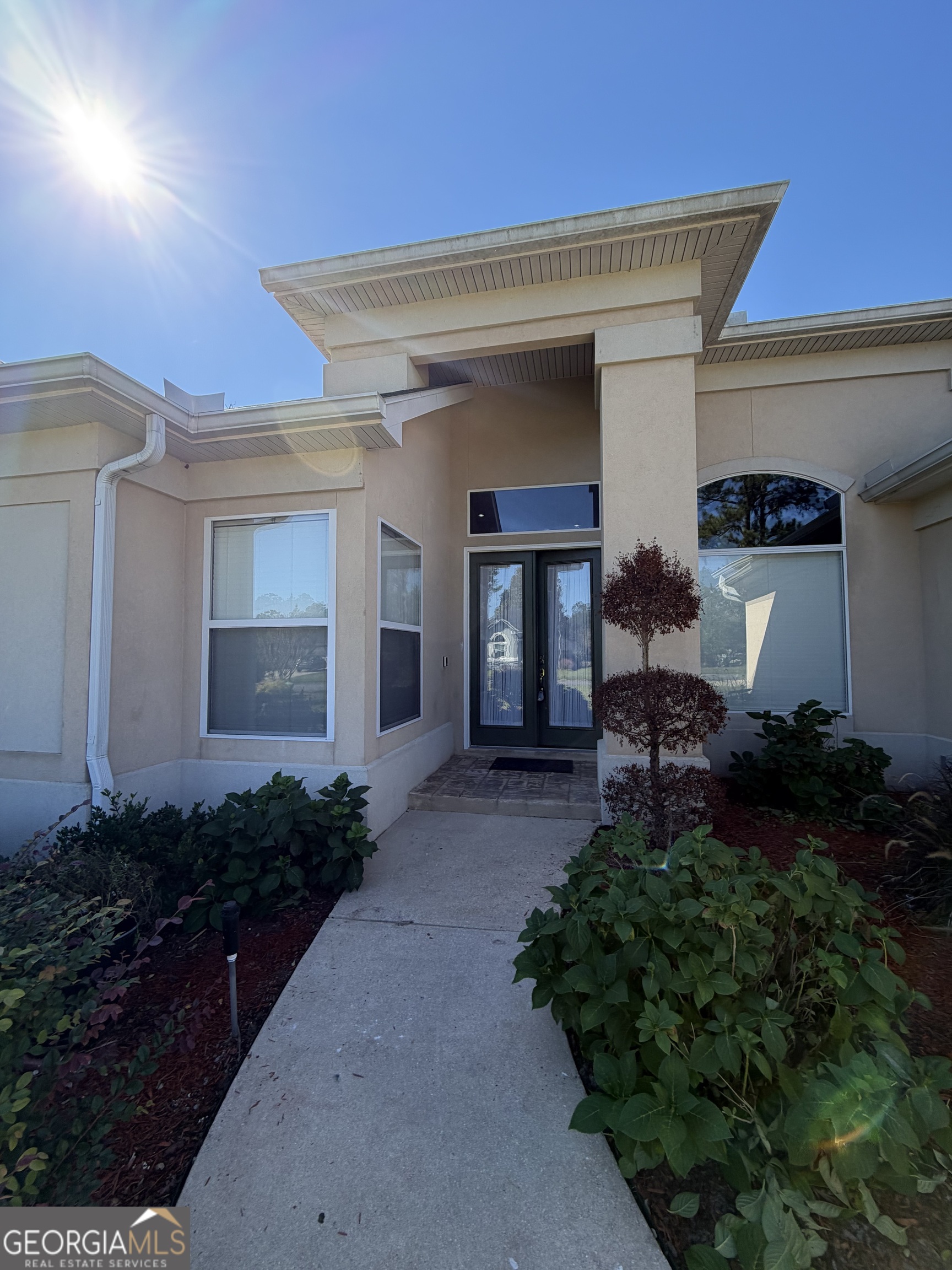 108 Heron's Nest Circle Kingsland, GA 31548 - Photo 2 of 62 a house view with a garden space