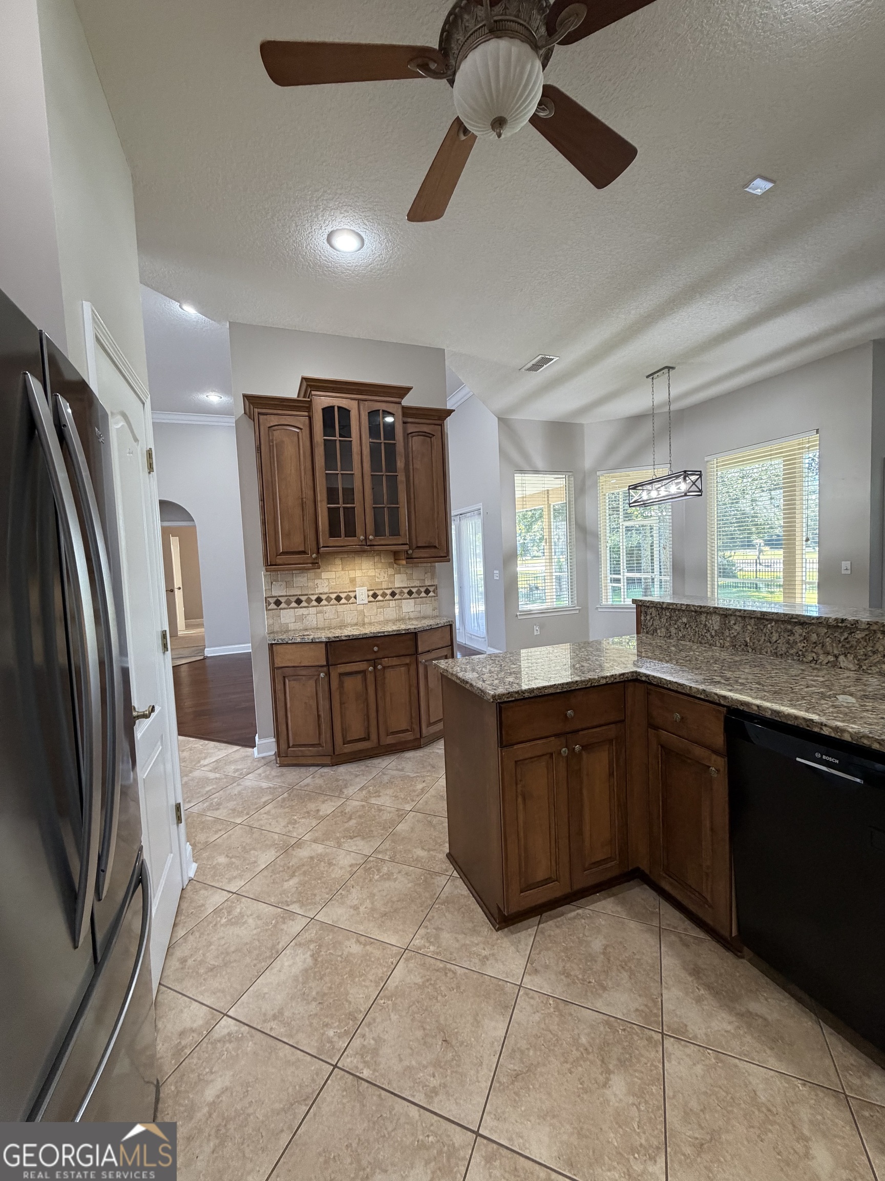 108 Heron's Nest Circle Kingsland, GA 31548 - Photo 21 of 62 a kitchen with stainless steel appliances granite countertop a stove sink and cabinets