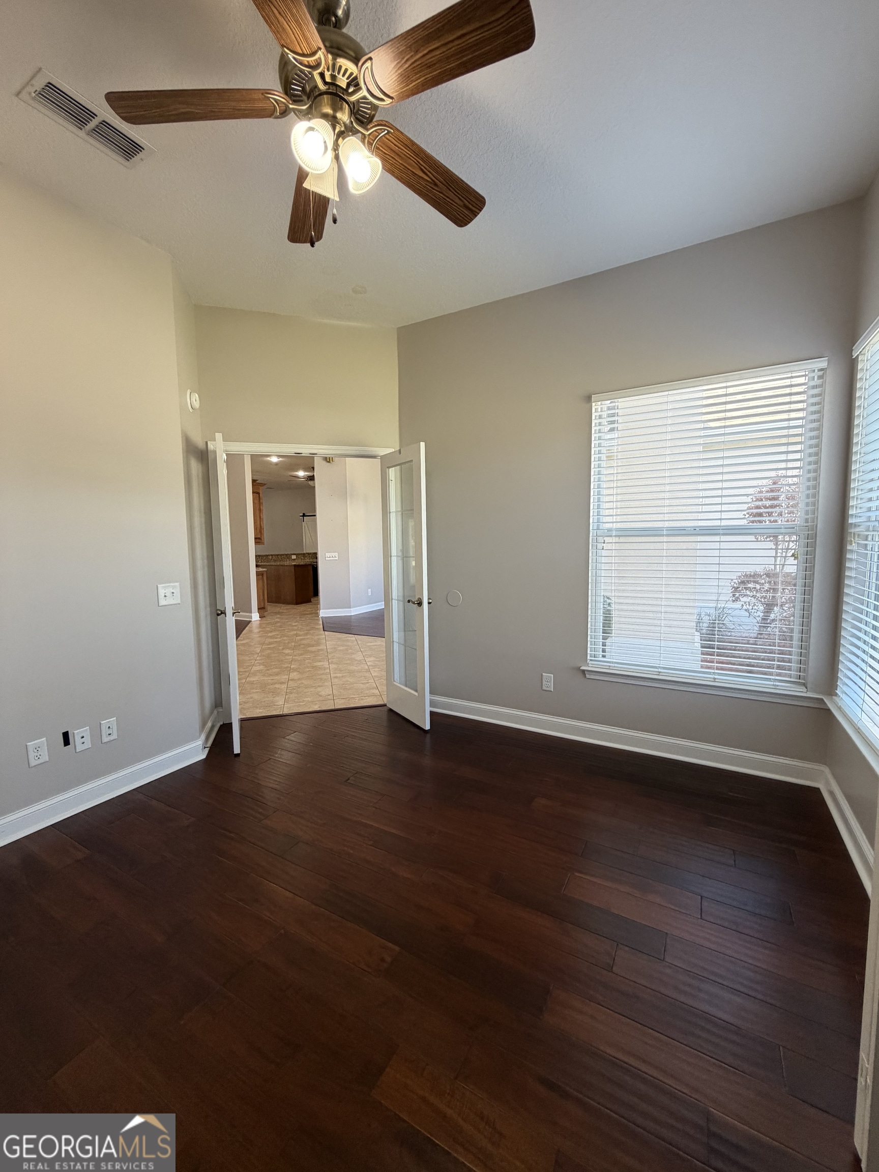 108 Heron's Nest Circle Kingsland, GA 31548 - Photo 23 of 62 a view of an empty room with wooden floor and a window