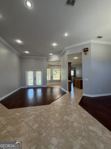 a view of a kitchen with a chandelier wooden floor and a chandelier