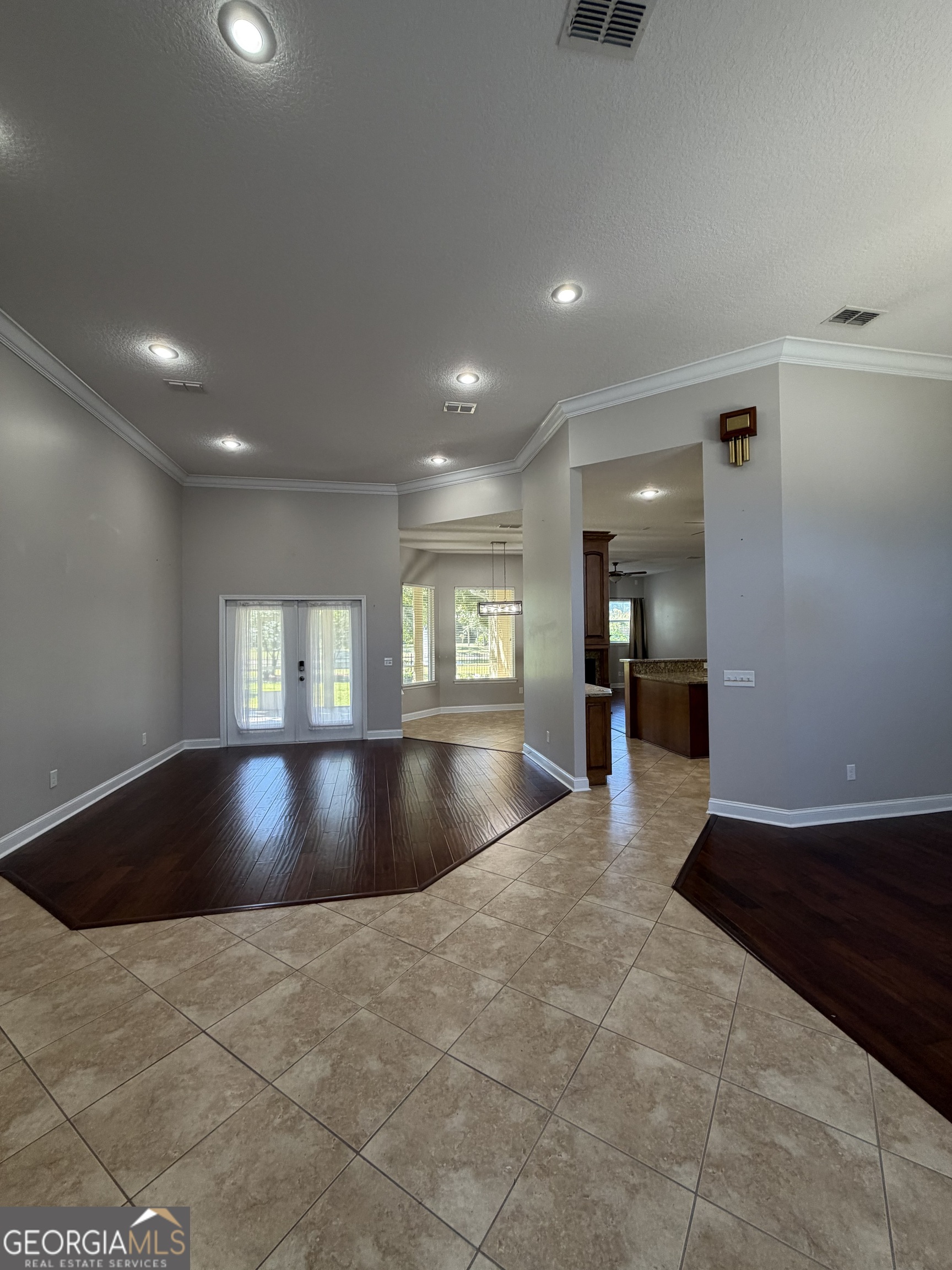 108 Heron's Nest Circle Kingsland, GA 31548 - Photo 4 of 62 a view of kitchen and empty room with windows