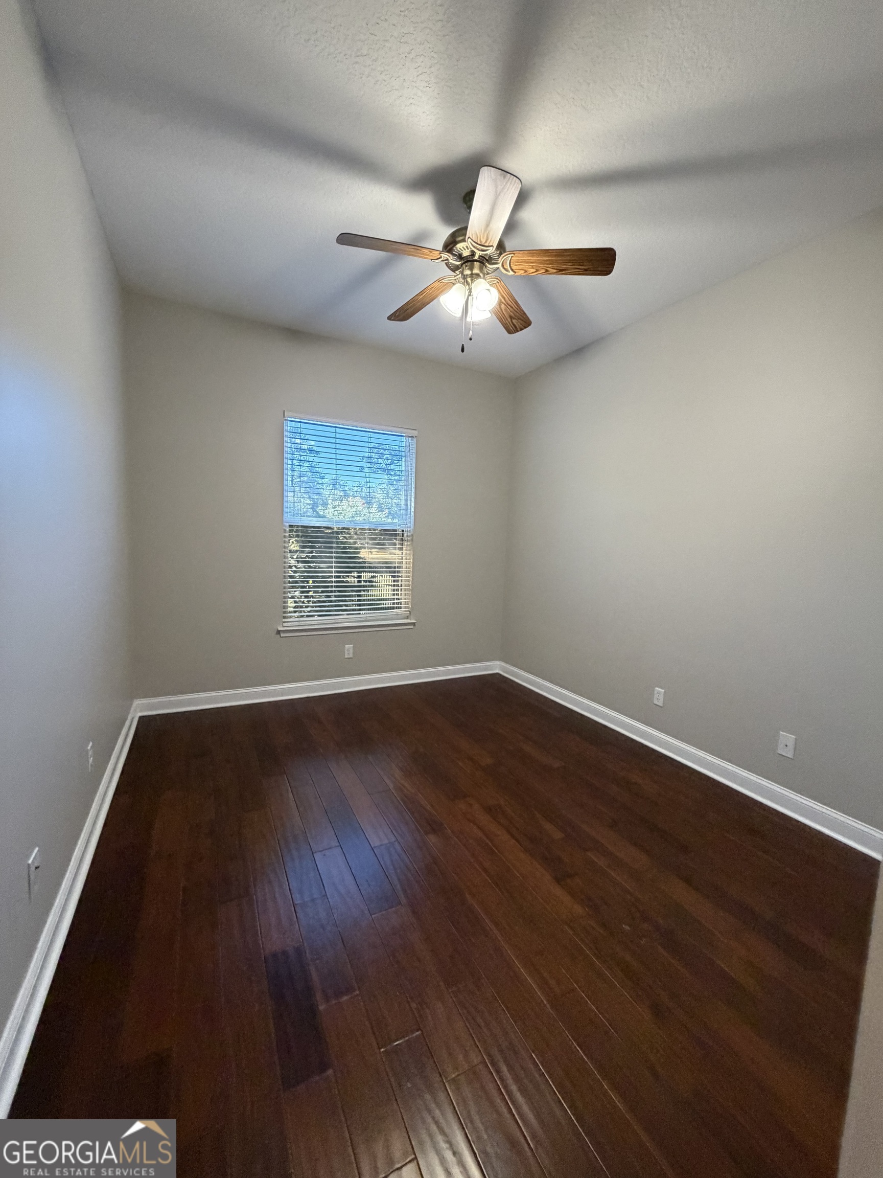 108 Heron's Nest Circle Kingsland, GA 31548 - Photo 43 of 62 a view of an empty room with wooden floor and a window