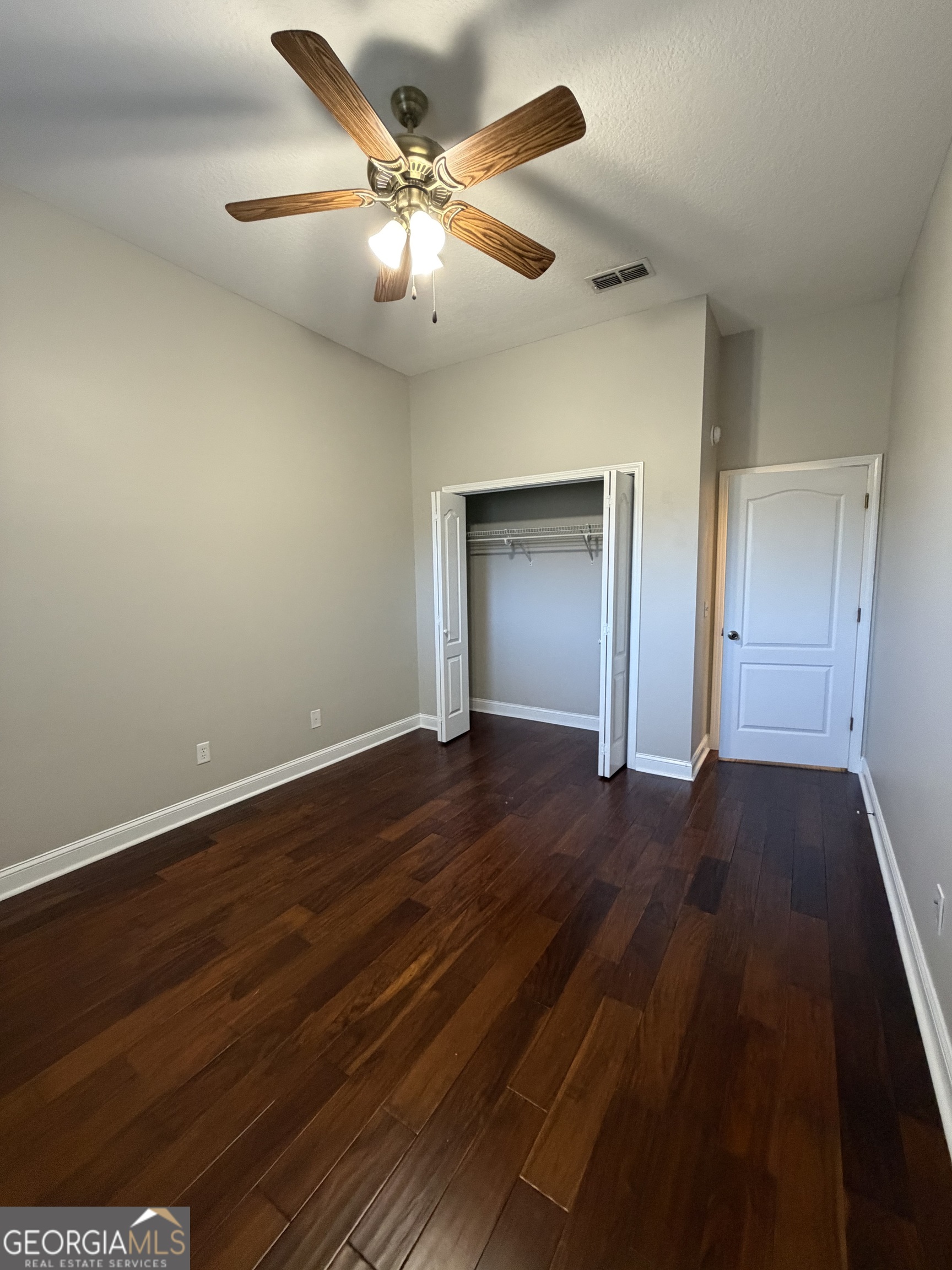108 Heron's Nest Circle Kingsland, GA 31548 - Photo 44 of 62 a view of an empty room with wooden floor