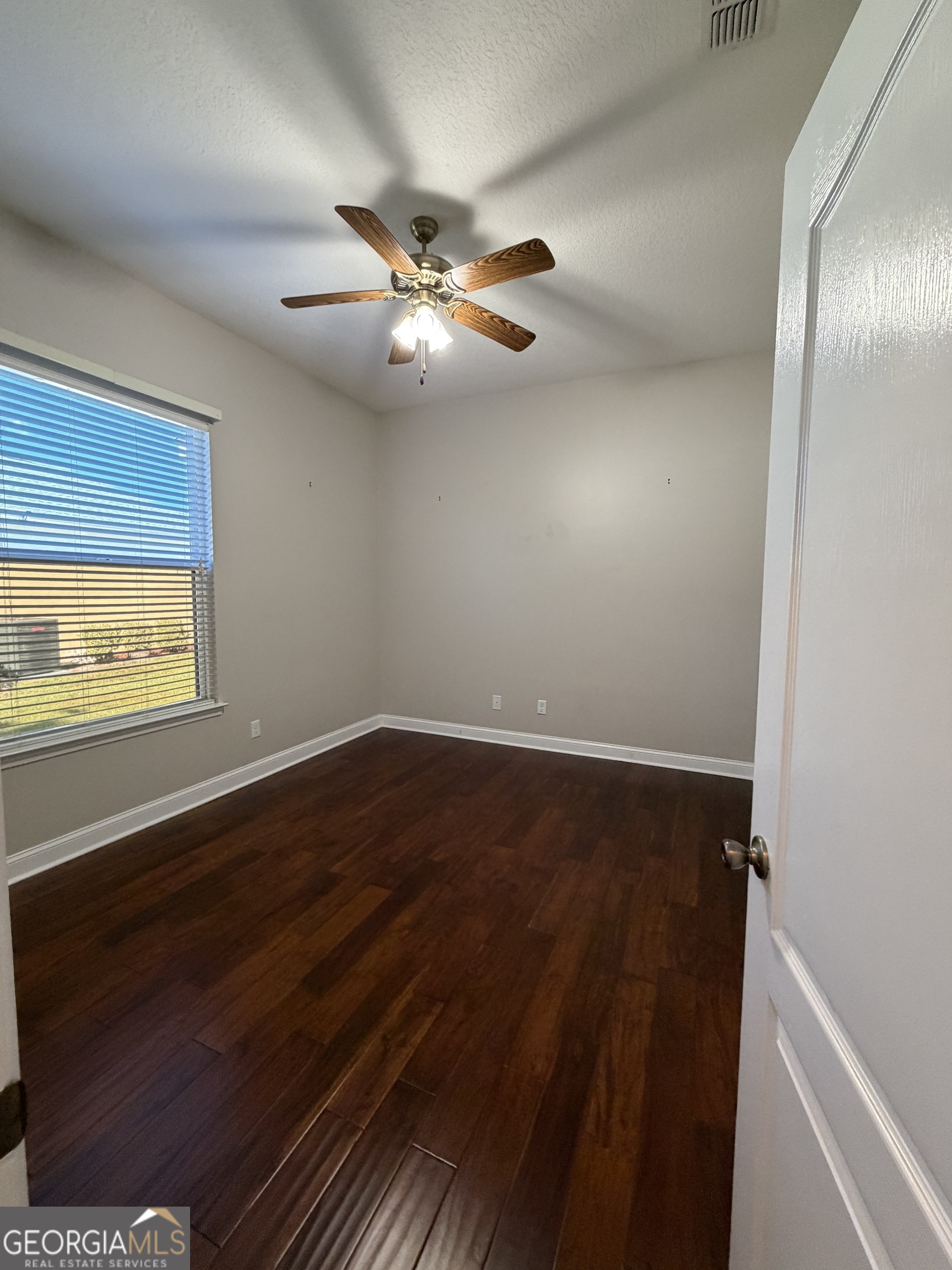 108 Heron's Nest Circle Kingsland, GA 31548 - Photo 49 of 62 an empty room with wooden floor closet and fan