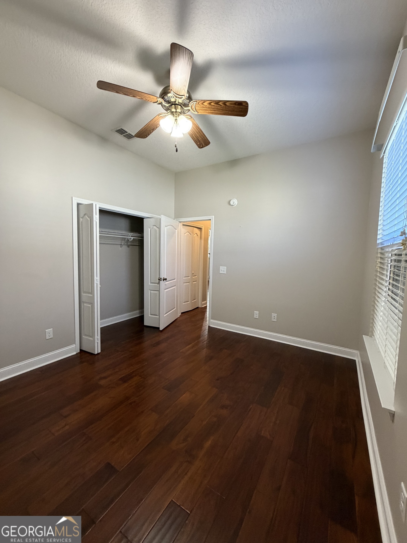 108 Heron's Nest Circle Kingsland, GA 31548 - Photo 50 of 62 a view of an empty room with wooden floor and a window