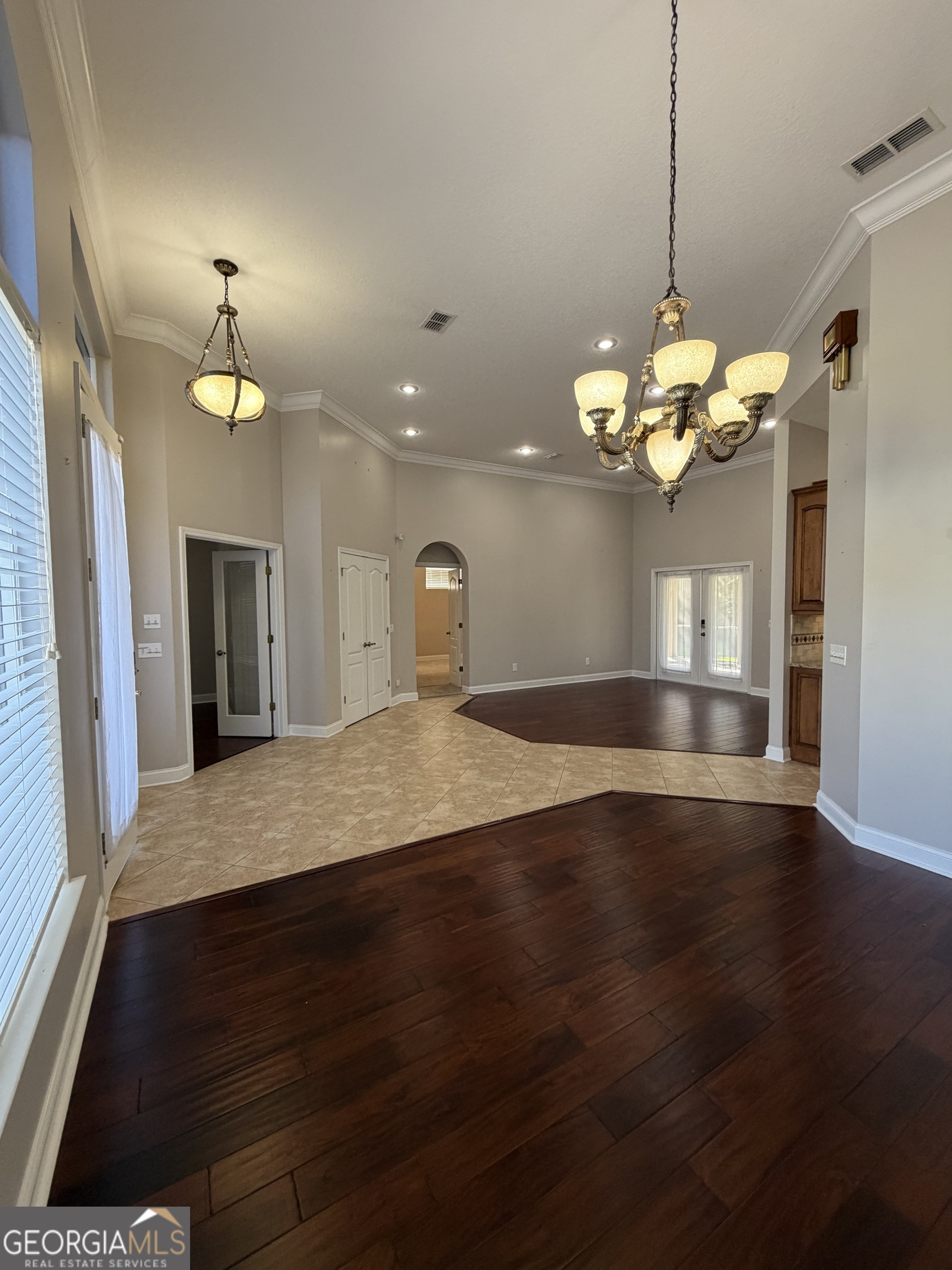 108 Heron's Nest Circle Kingsland, GA 31548 - Photo 5 of 62 a view of a kitchen with a chandelier wooden floor and a chandelier
