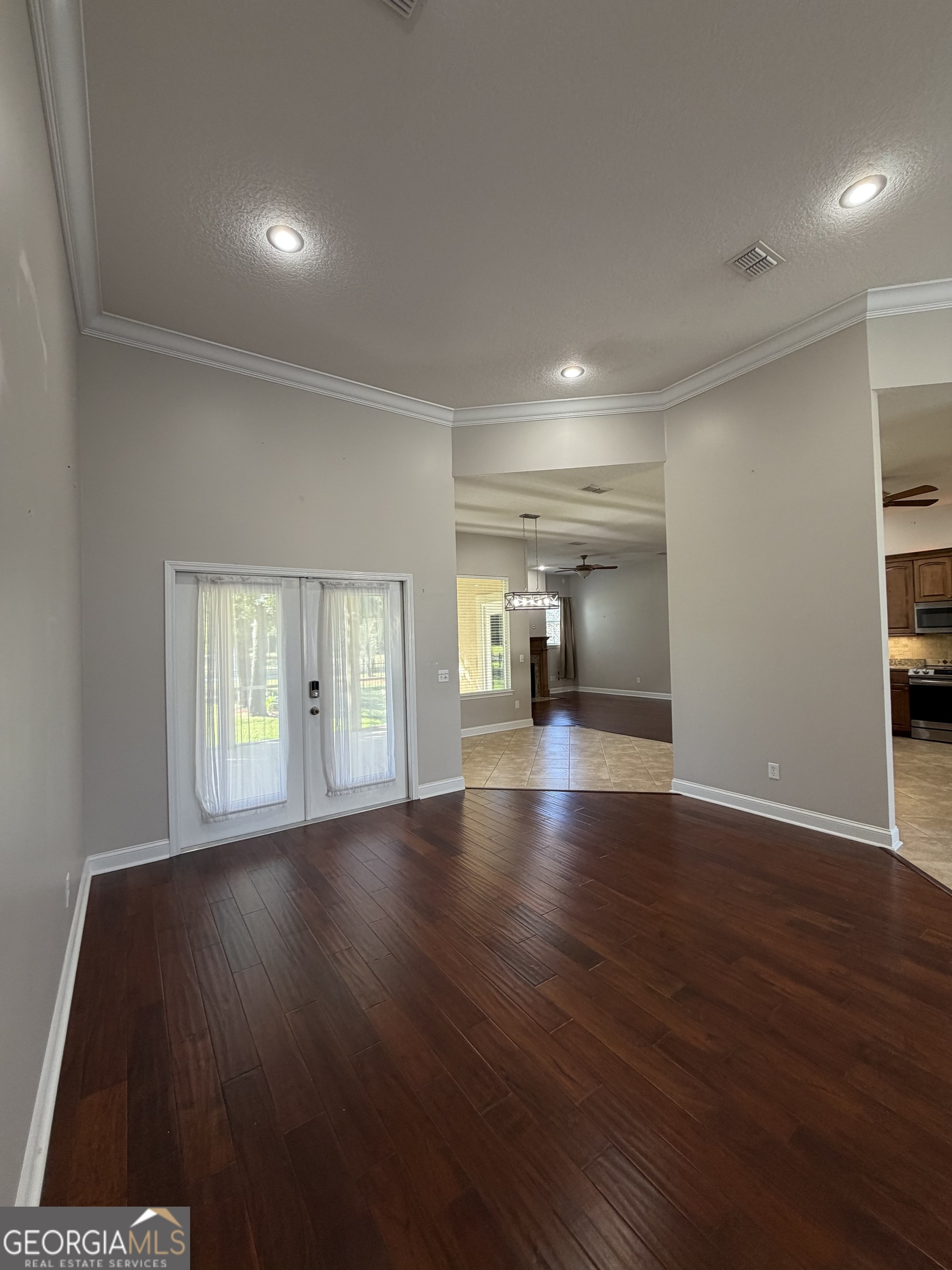 108 Heron's Nest Circle Kingsland, GA 31548 - Photo 9 of 62 an empty room with wooden floor and windows