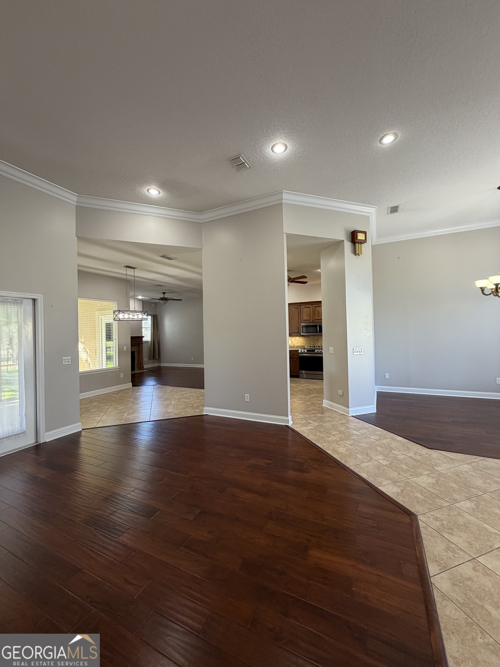 108 Heron's Nest Circle Kingsland, GA 31548 - Photo 10 of 62 a view of empty room with wooden floor and kitchen