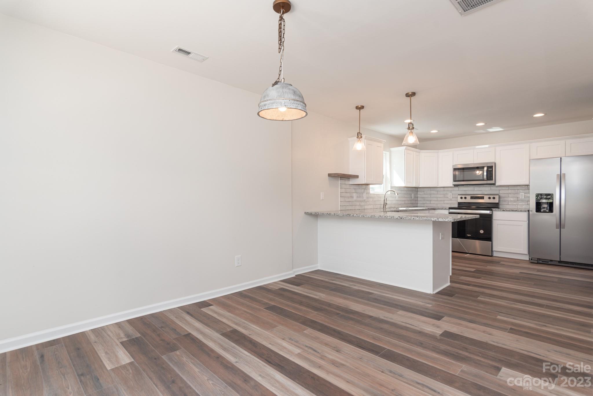 693 Gibson Drive Northwest Concord, NC 28025 - Photo 2 of 12 a view of kitchen with wooden floor and window