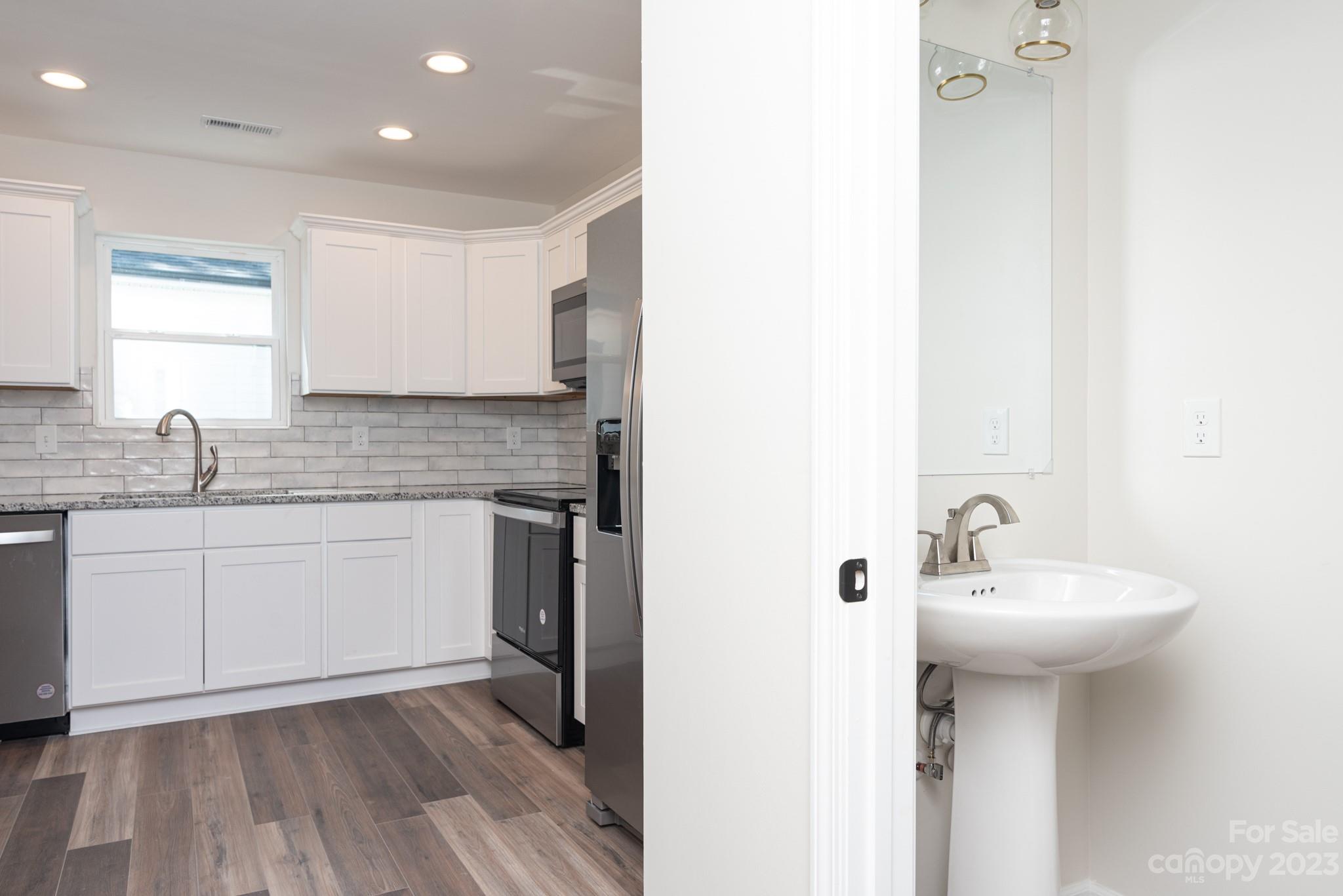 693 Gibson Drive Northwest Concord, NC 28025 - Photo 5 of 12 a kitchen with a sink cabinets and wooden floor