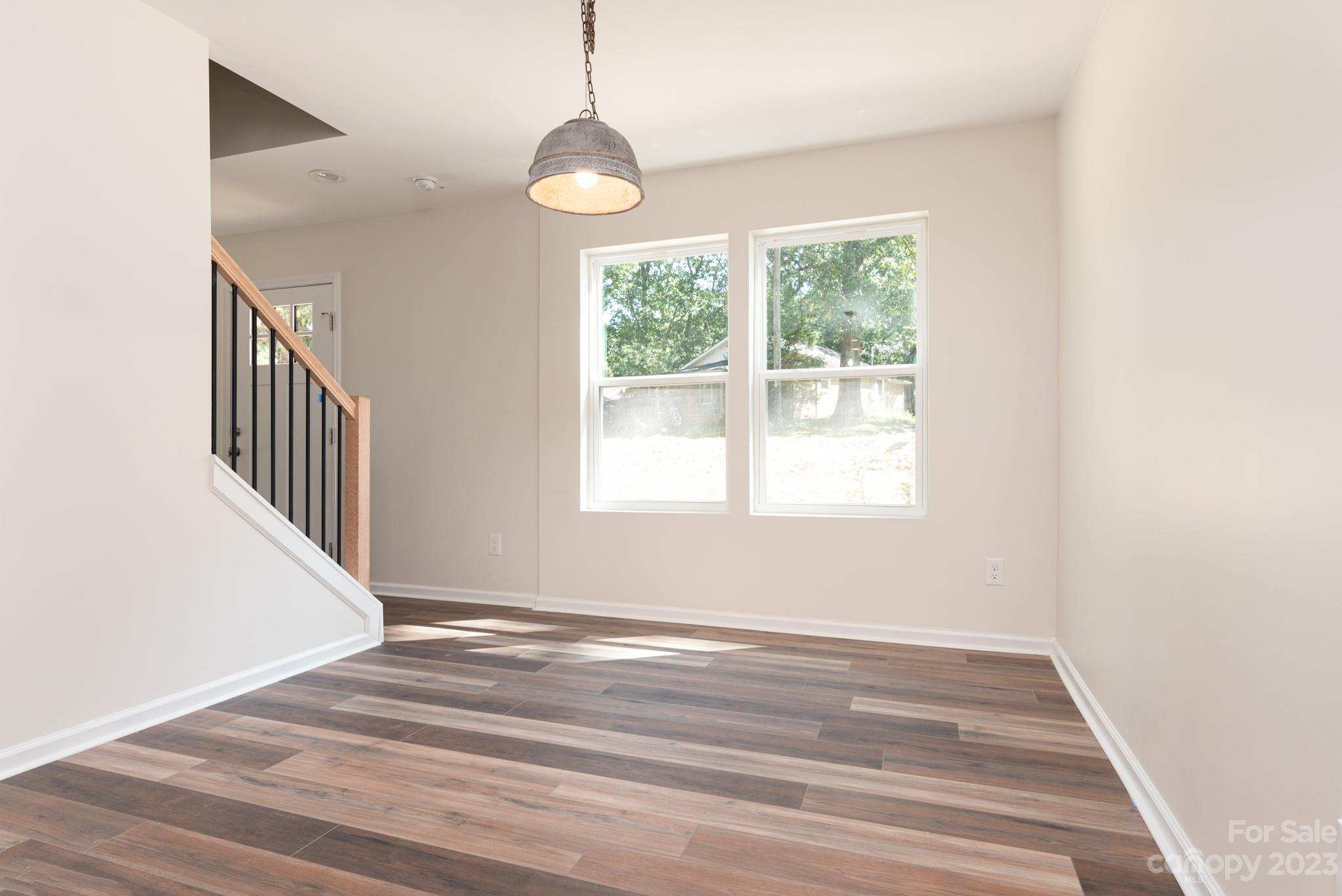 693 Gibson Drive Northwest Concord, NC 28025 - Photo 6 of 12 a view of an empty room with wooden floor and a window