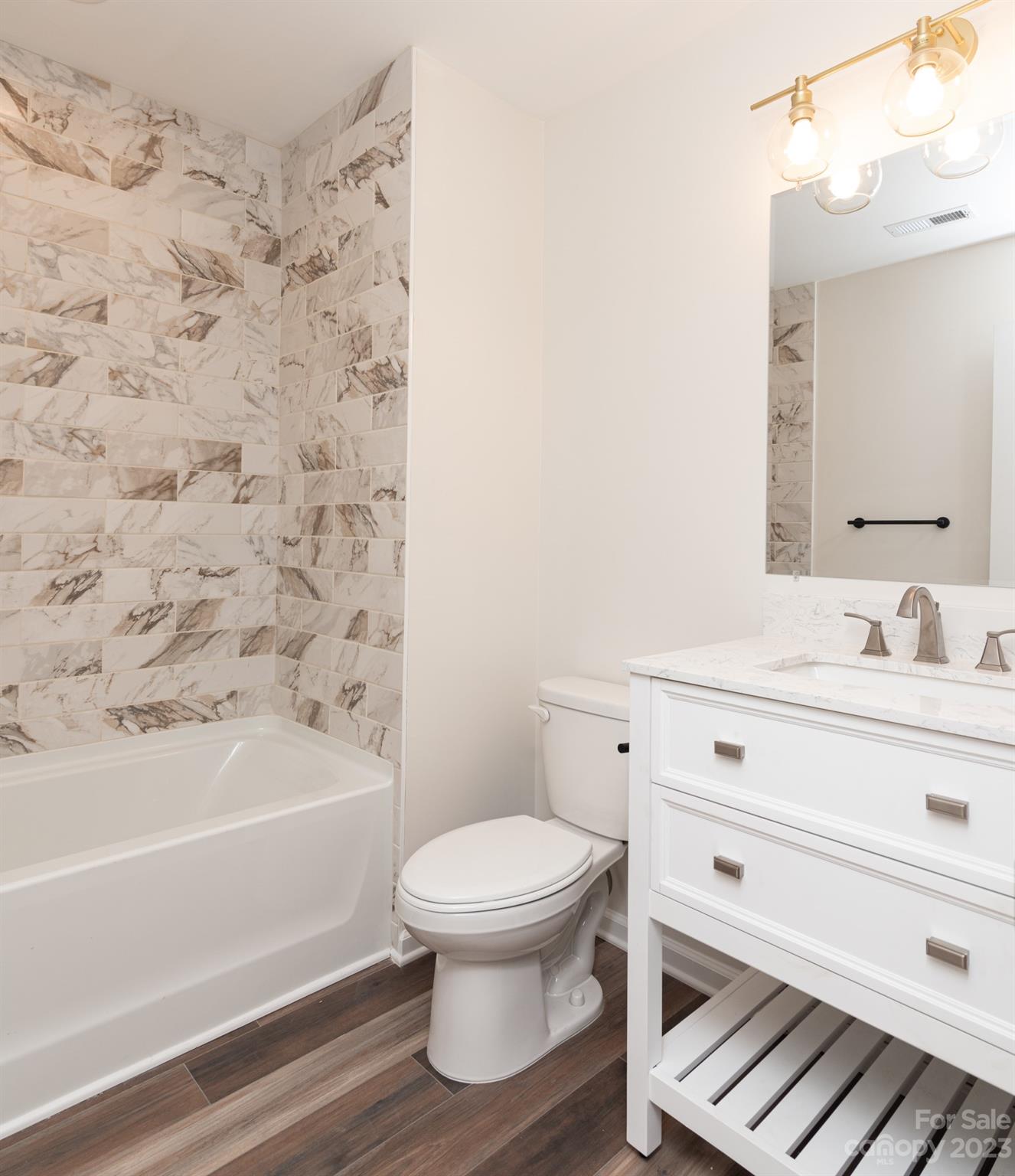 693 Gibson Drive Northwest Concord, NC 28025 - Photo 8 of 12 a bathroom with a sink a toilet and a bathtub