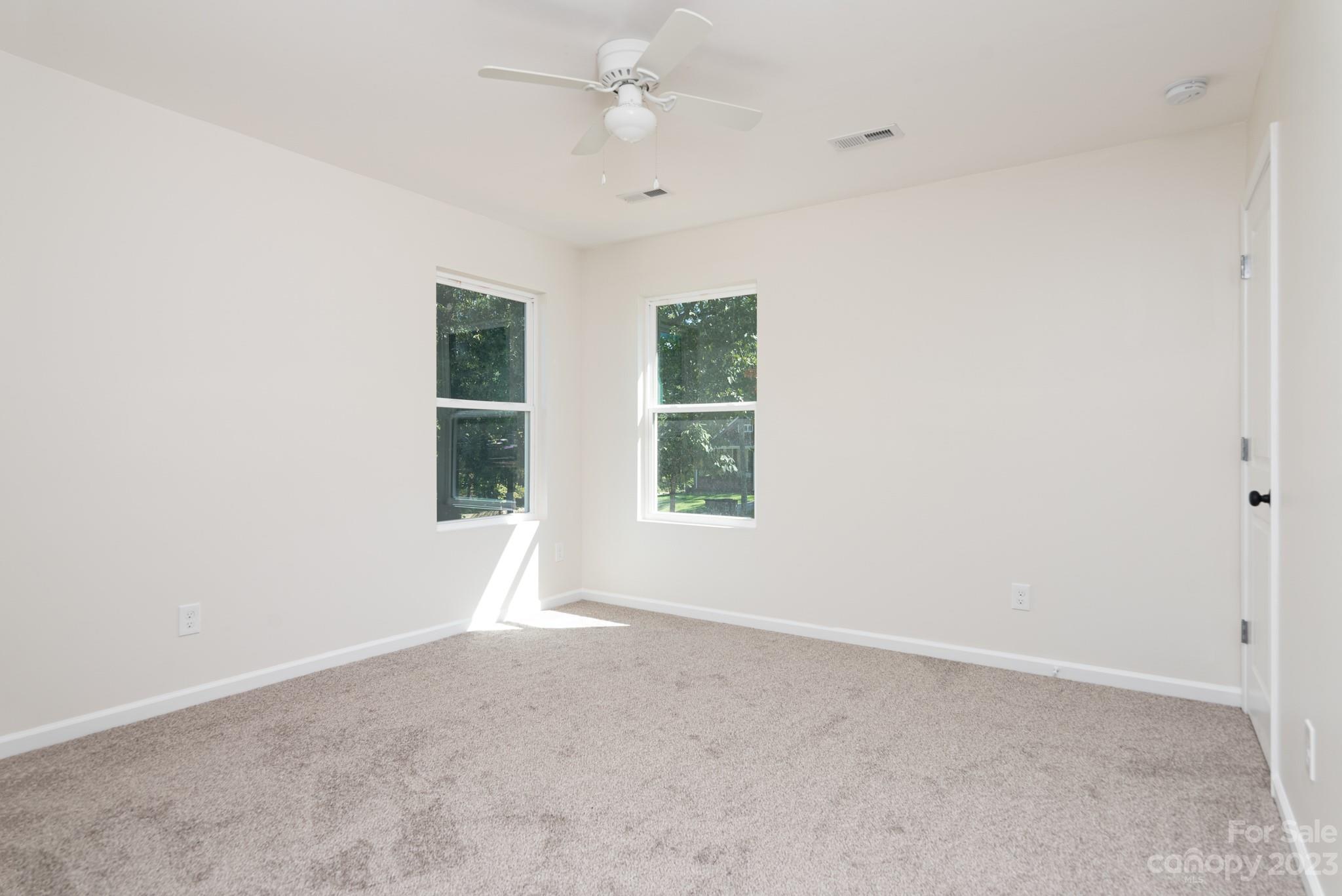 693 Gibson Drive Northwest Concord, NC 28025 - Photo 9 of 12 an empty room with a window and ceiling fan