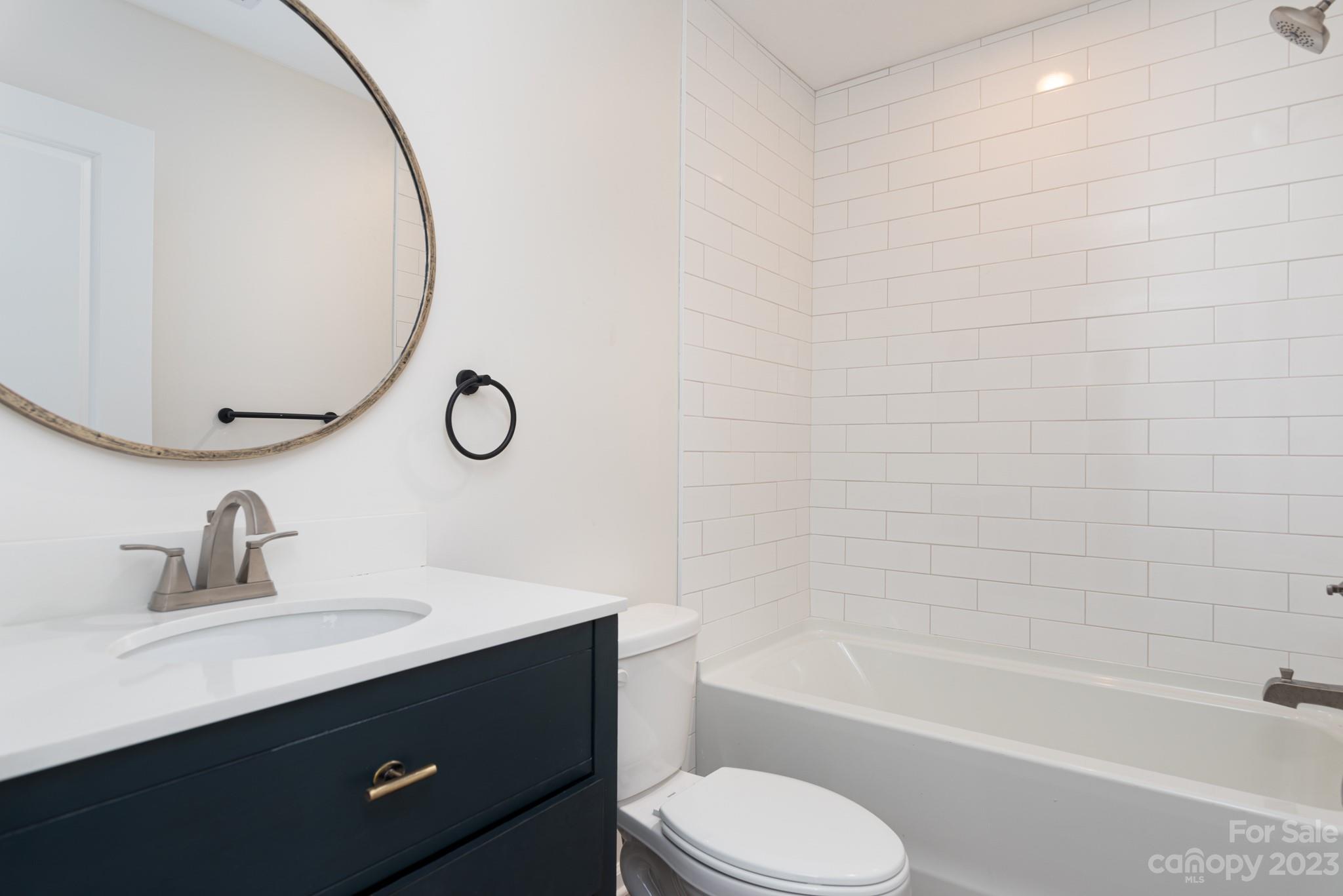 693 Gibson Drive Northwest Concord, NC 28025 - Photo 10 of 12 a bathroom with a sink a toilet and a mirror