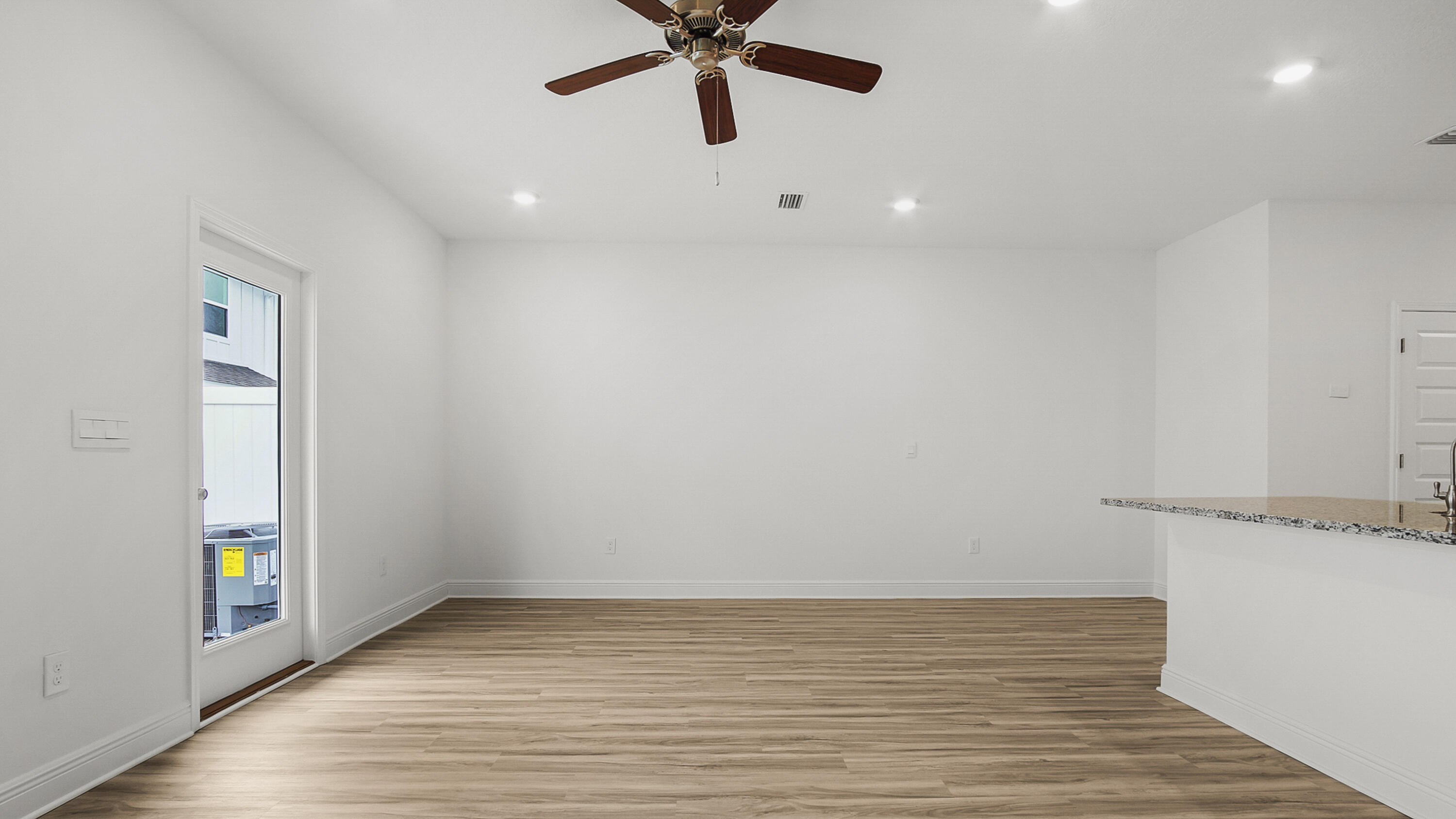 64 Phoenix Street Santa Rosa Beach, FL 32459 - Photo 13 of 34 a view of an empty room with wooden floor and a window