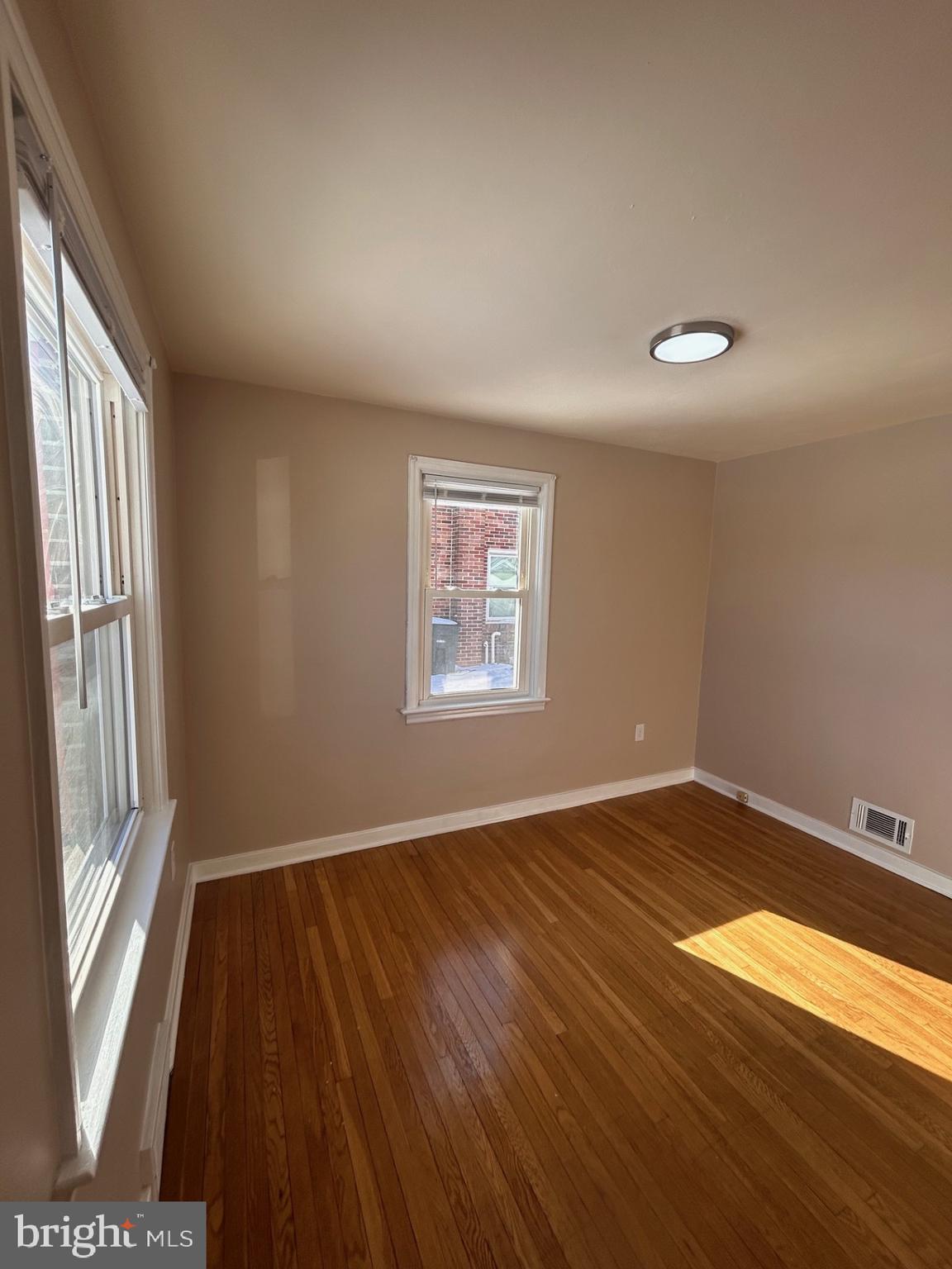 340 Edgewood Road York, PA 17402 - Photo 4 of 14 an empty room with wooden floor and windows