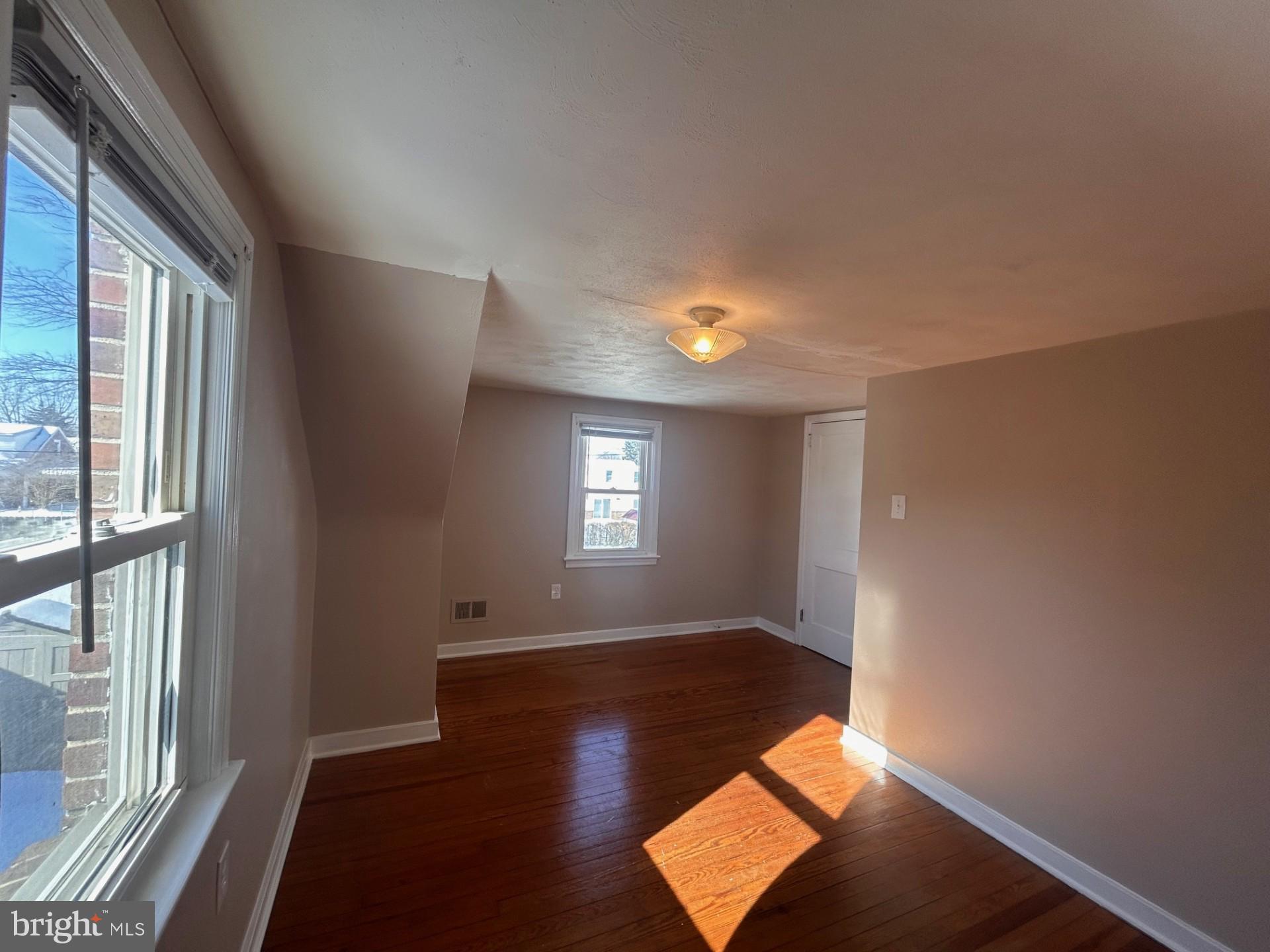 340 Edgewood Road York, PA 17402 - Photo 10 of 14 an empty room with wooden floor and windows