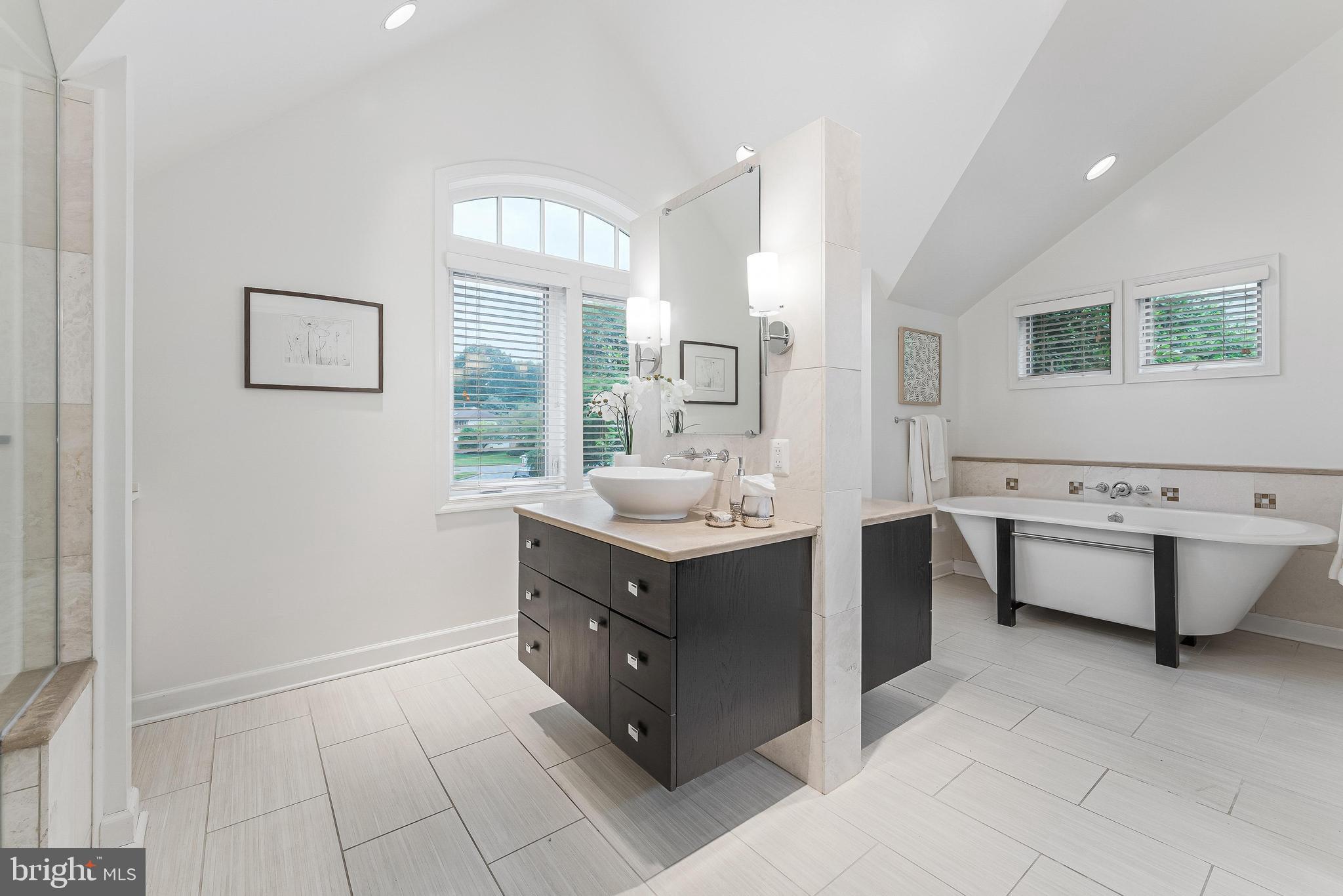 1655 Hunting Ridge Court McLean, VA 22101 - Photo 25 of 38 a bathroom with a tub sink and mirror