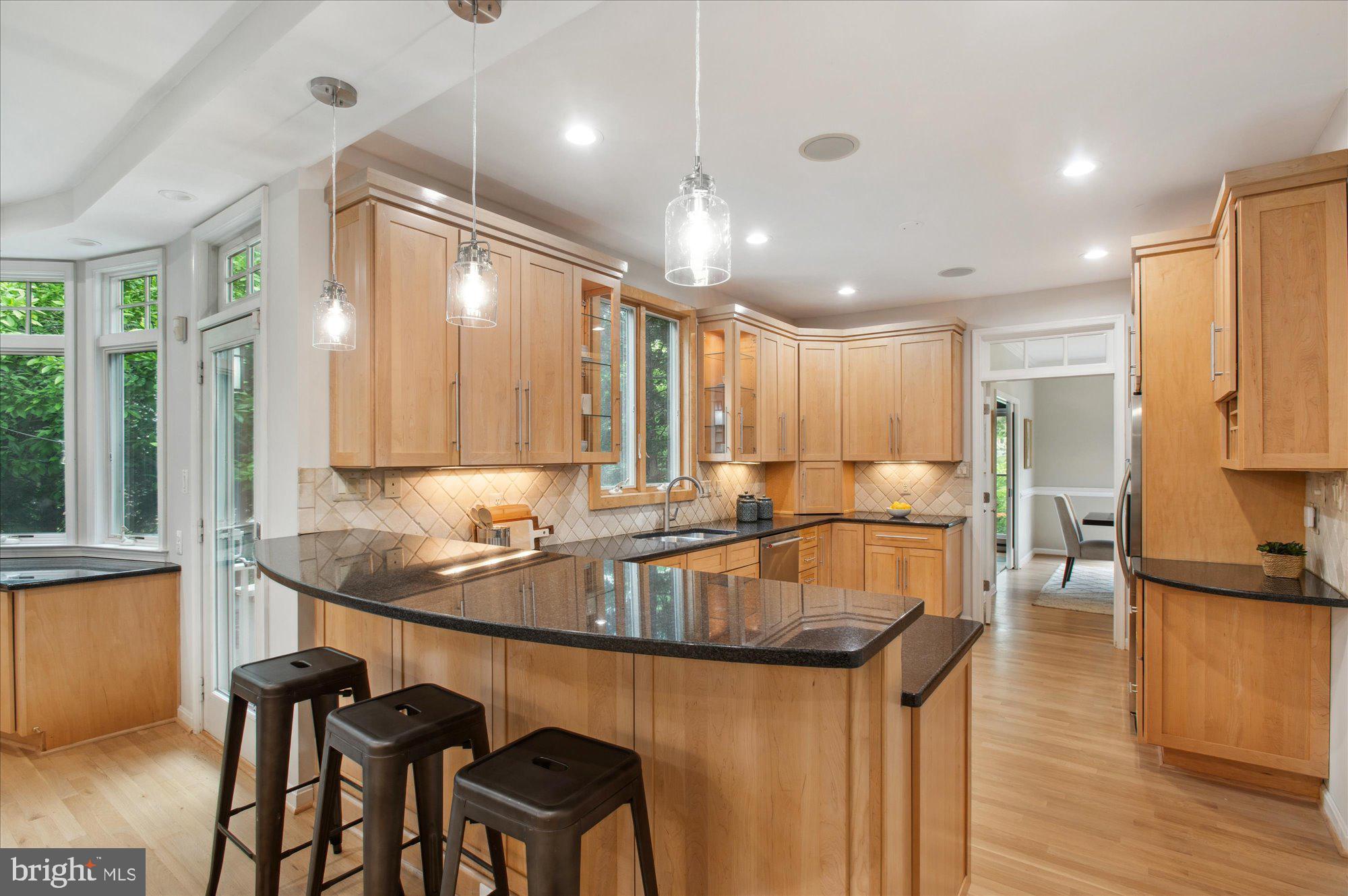 1655 Hunting Ridge Court McLean, VA 22101 - Photo 8 of 38 a kitchen with granite countertop sink cabinets and stainless steel appliances