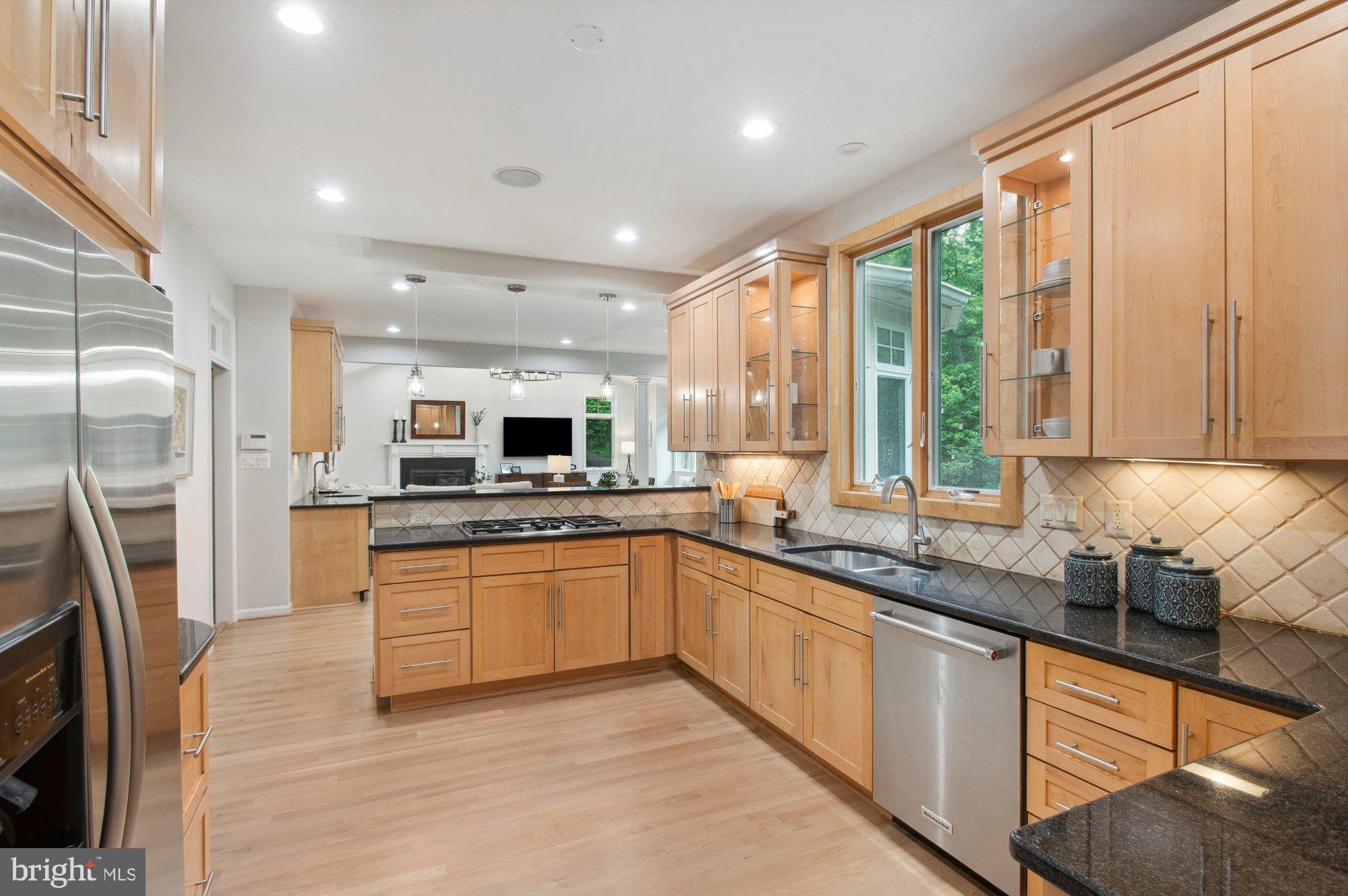 1655 Hunting Ridge Court McLean, VA 22101 - Photo 10 of 38 a large kitchen with stainless steel appliances granite countertop a sink and a stove