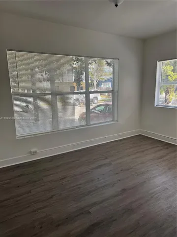 a view of wooden floor and cabinet in a room