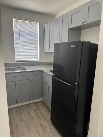 a kitchen with a refrigerator and a sink