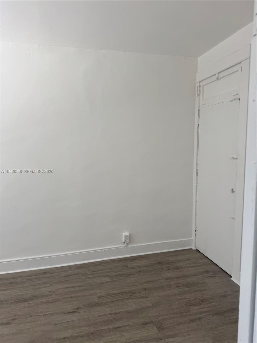 1552 Southwest 2nd Street, Unit 1 Miami, FL 33135 - Photo 9 of 11 a view of an empty room with wooden floor