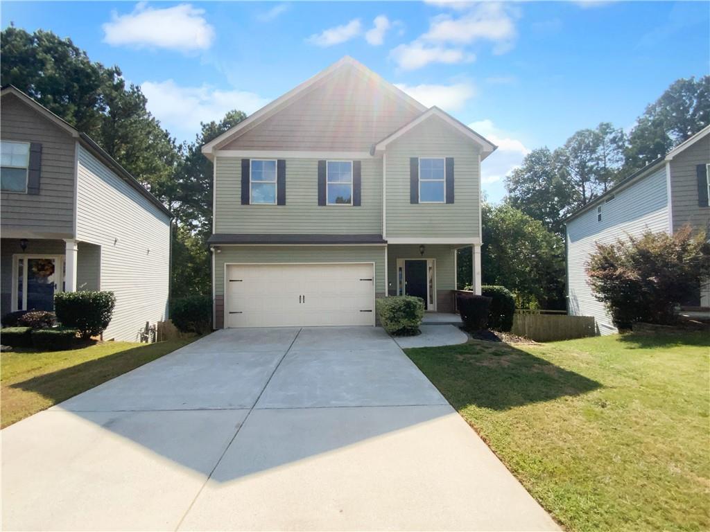 a front view of a house with a yard and garage