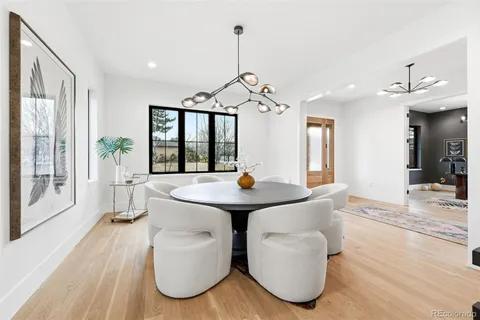 a living room with furniture a window and a chandelier
