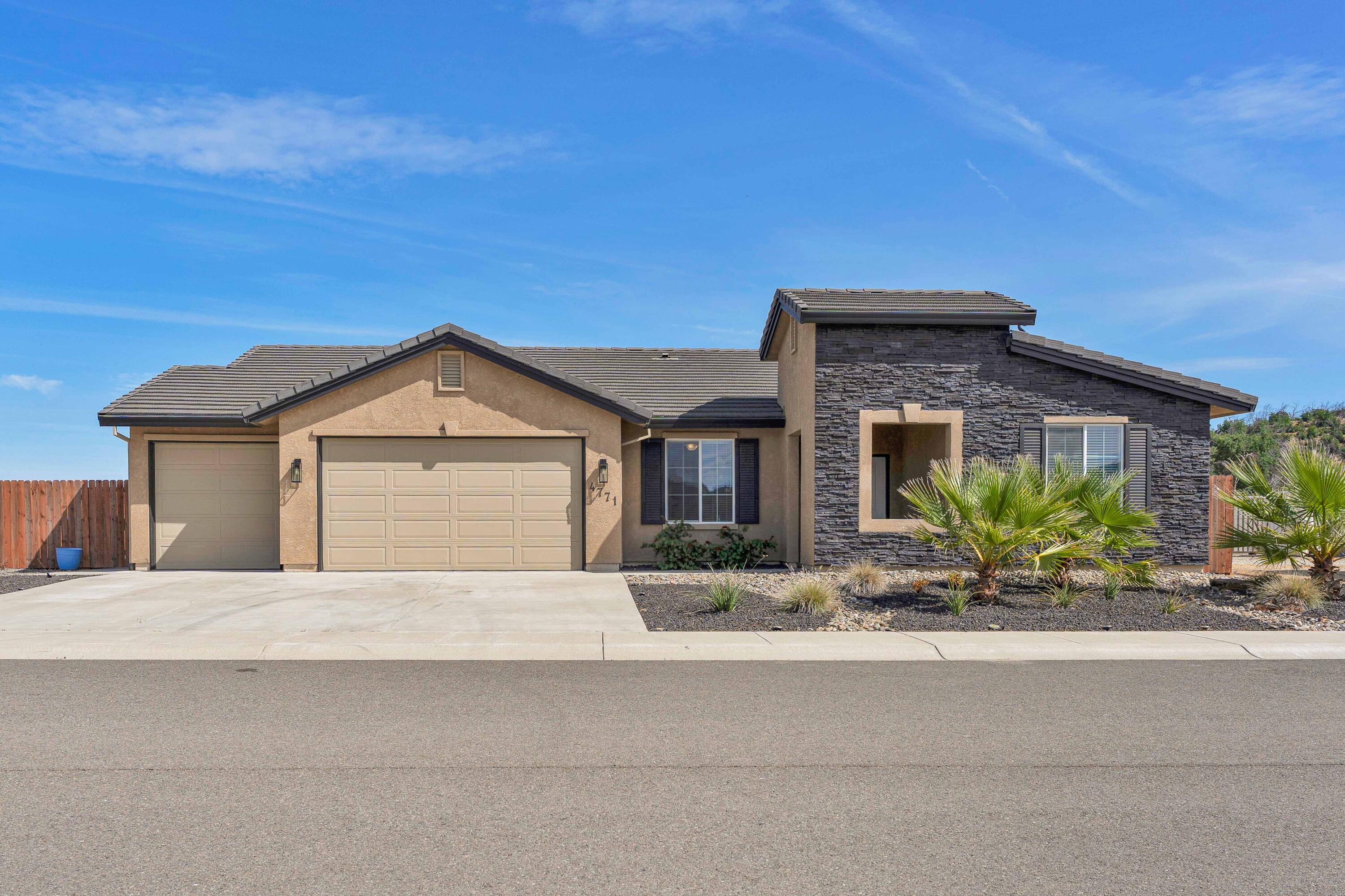 4771 Lower Springs Road Redding, CA 96001 - Photo 1 of 30 a front view of a house with a yard and garage