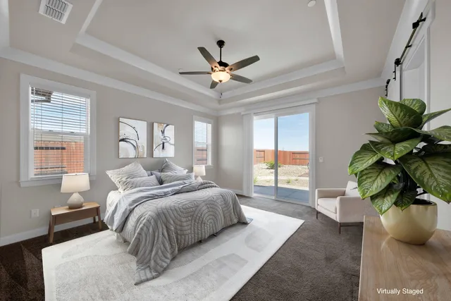 a bedroom with a large bed and a potted plant