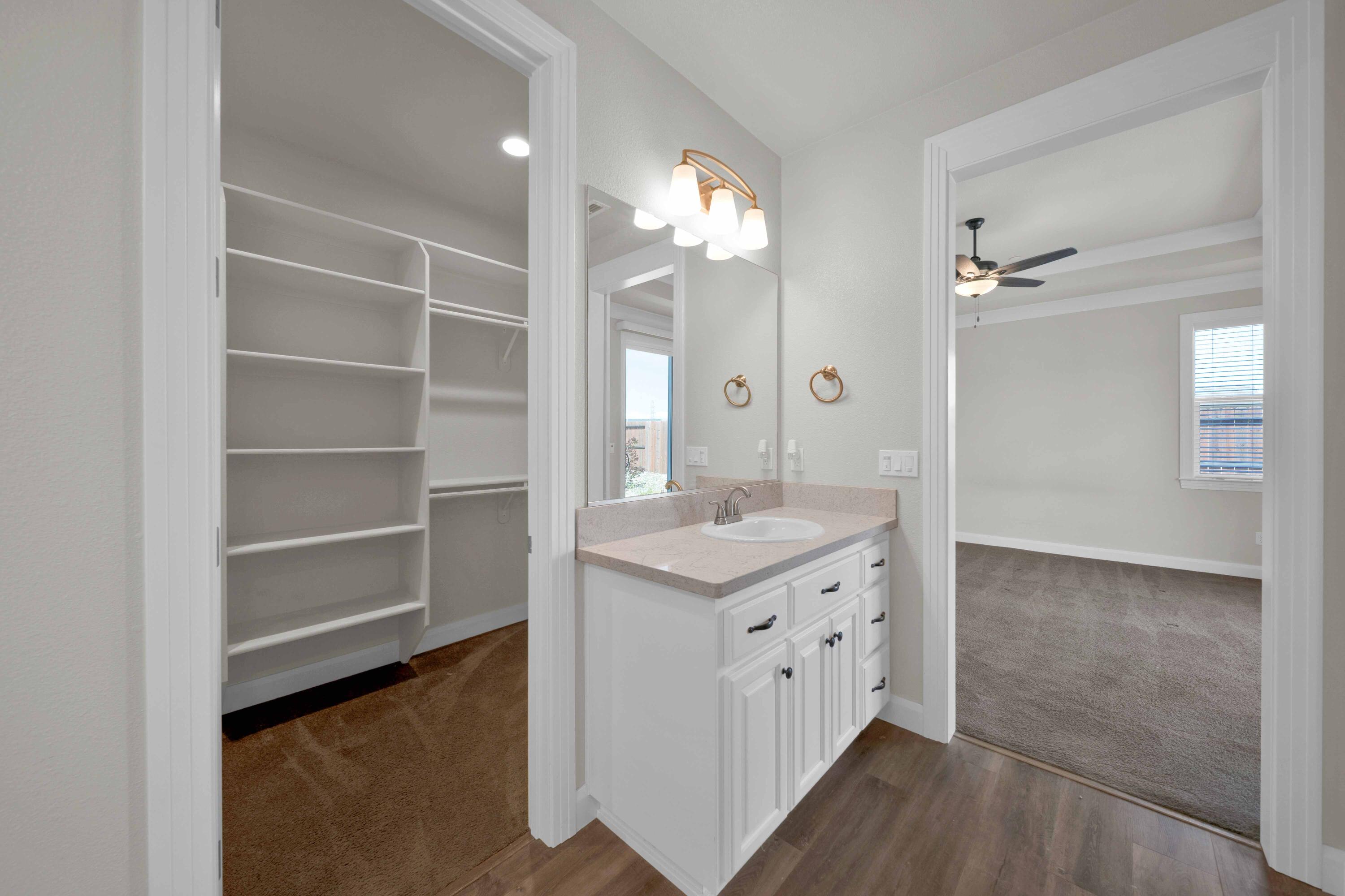 4771 Lower Springs Road Redding, CA 96001 - Photo 15 of 30 a bathroom with a granite countertop sink a mirror and a shower
