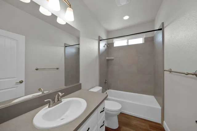 a bathroom with a sink toilet bathtub and vanity