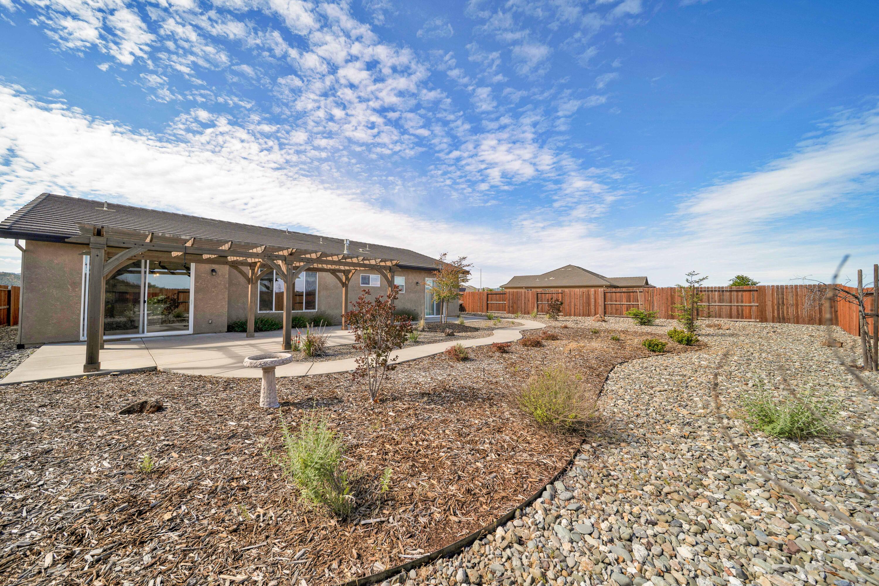 4771 Lower Springs Road Redding, CA 96001 - Photo 26 of 30 a view of a house with wooden fence
