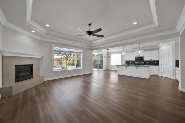 an open kitchen with a sink and a fireplace