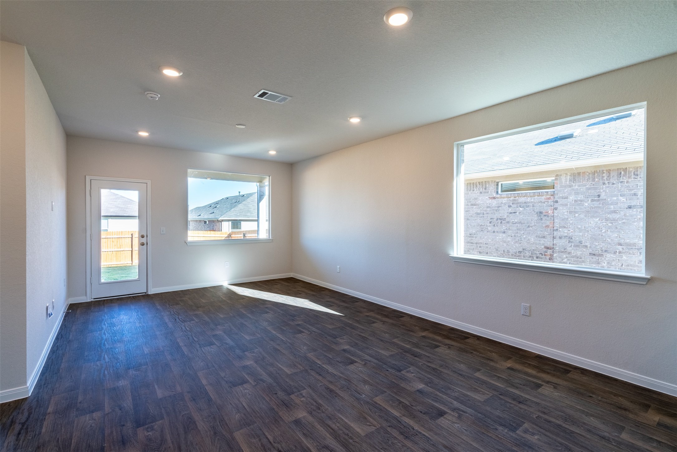 233 Brooklyn Drive Georgetown, TX 78626 - Photo 7 of 21 a view of an empty room with wooden floor and a window