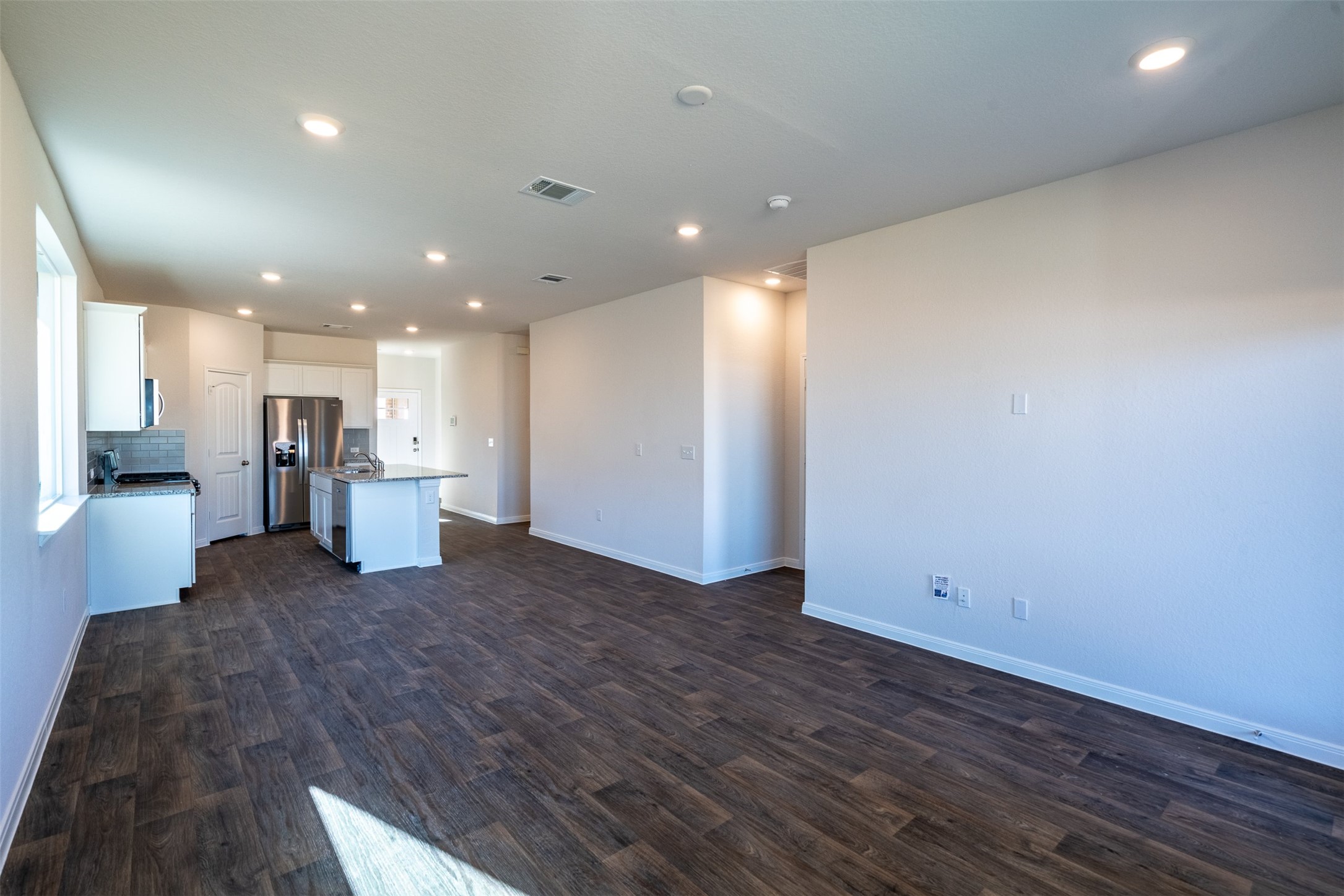 233 Brooklyn Drive Georgetown, TX 78626 - Photo 9 of 21 a view of a big room with wooden floor and a kitchen