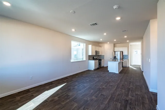 a view of a kitchen with a sink and a refrigerator